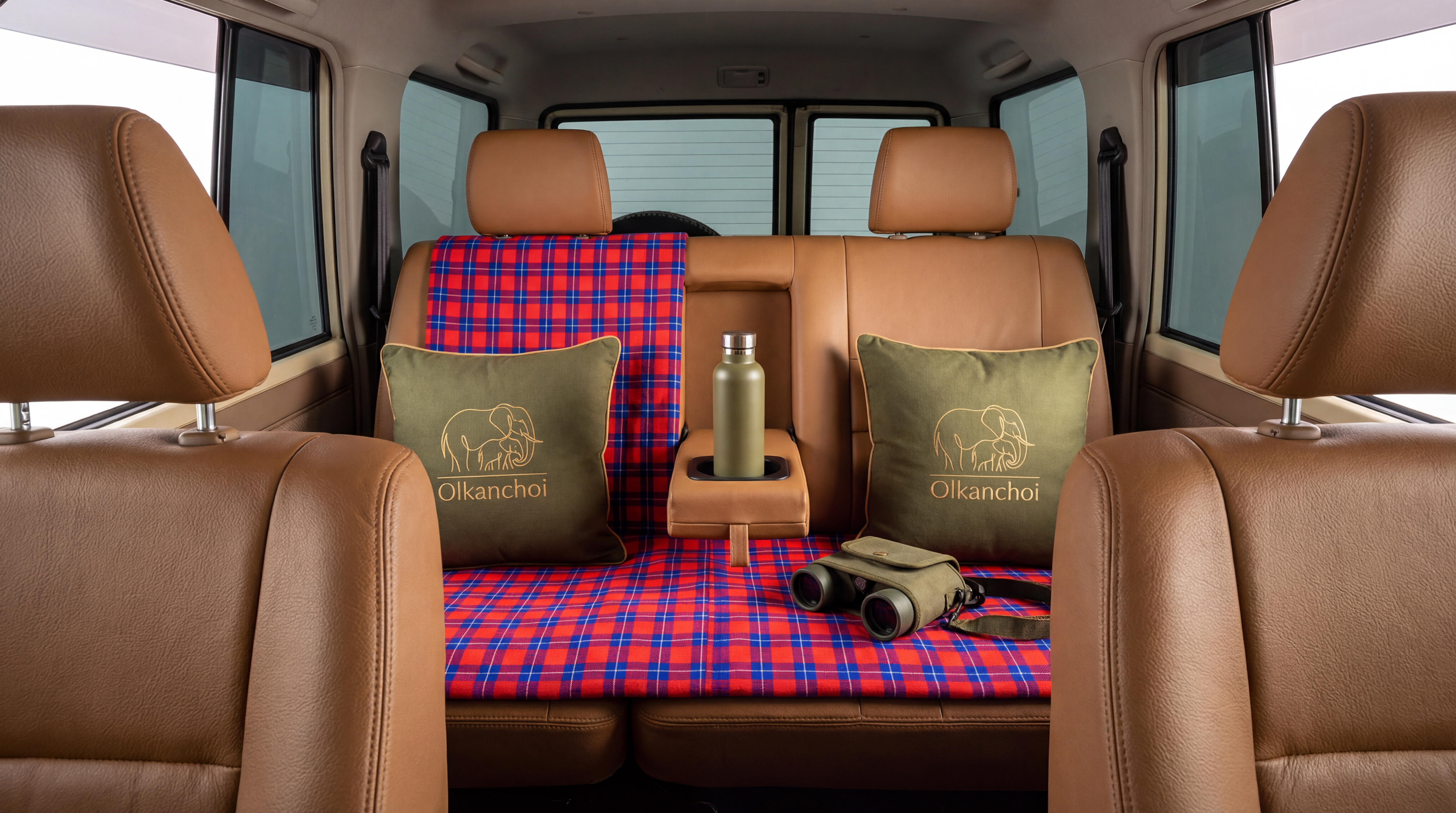 Olkanchoi vehicle detail — branded cushions, binoculars and thermos ready for the drive